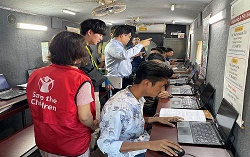 写真　移動式研修センターで学ぶ青少年の様子（セーブ・ザ・チルドレン提供）